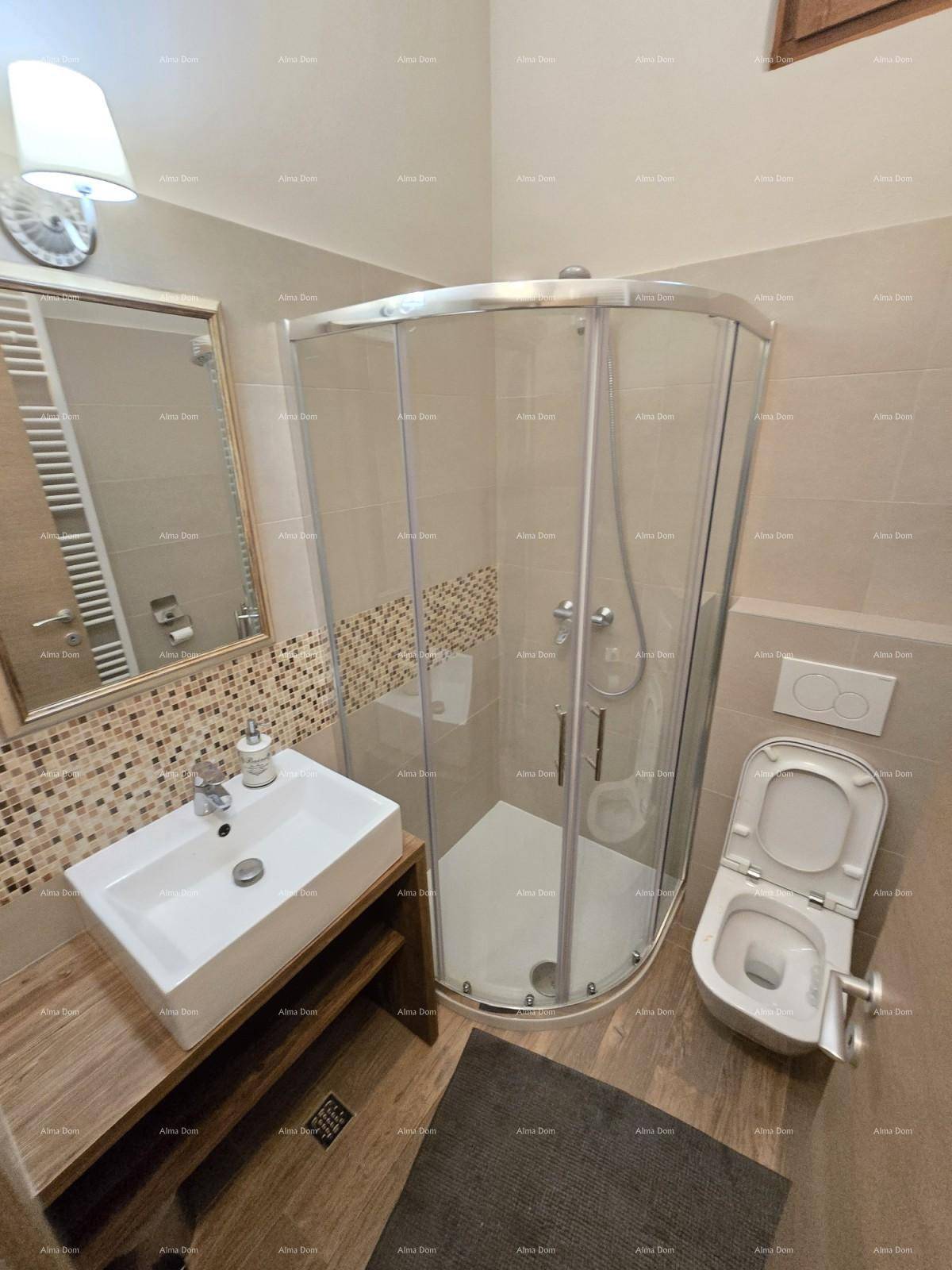 Modernes Badezimmer mit Duschkabine, wandhängendem WC und einem Waschbecken auf Holzunterschrank.