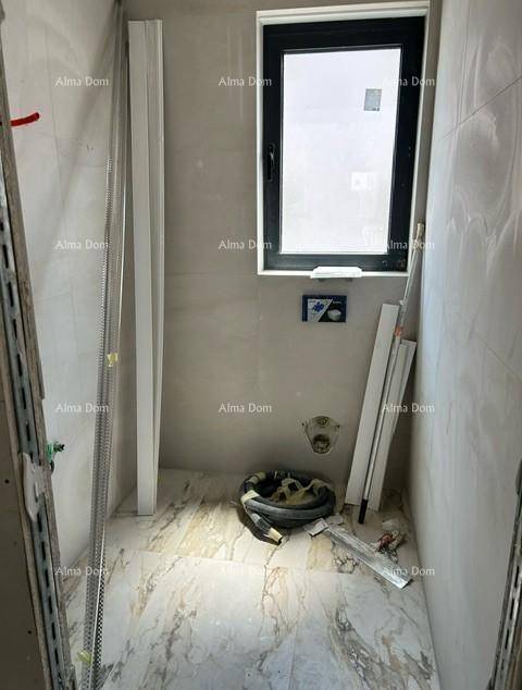 Badezimmer im Bau mit Fenster und vorbereiteter Duschfläche, hell gefliest.