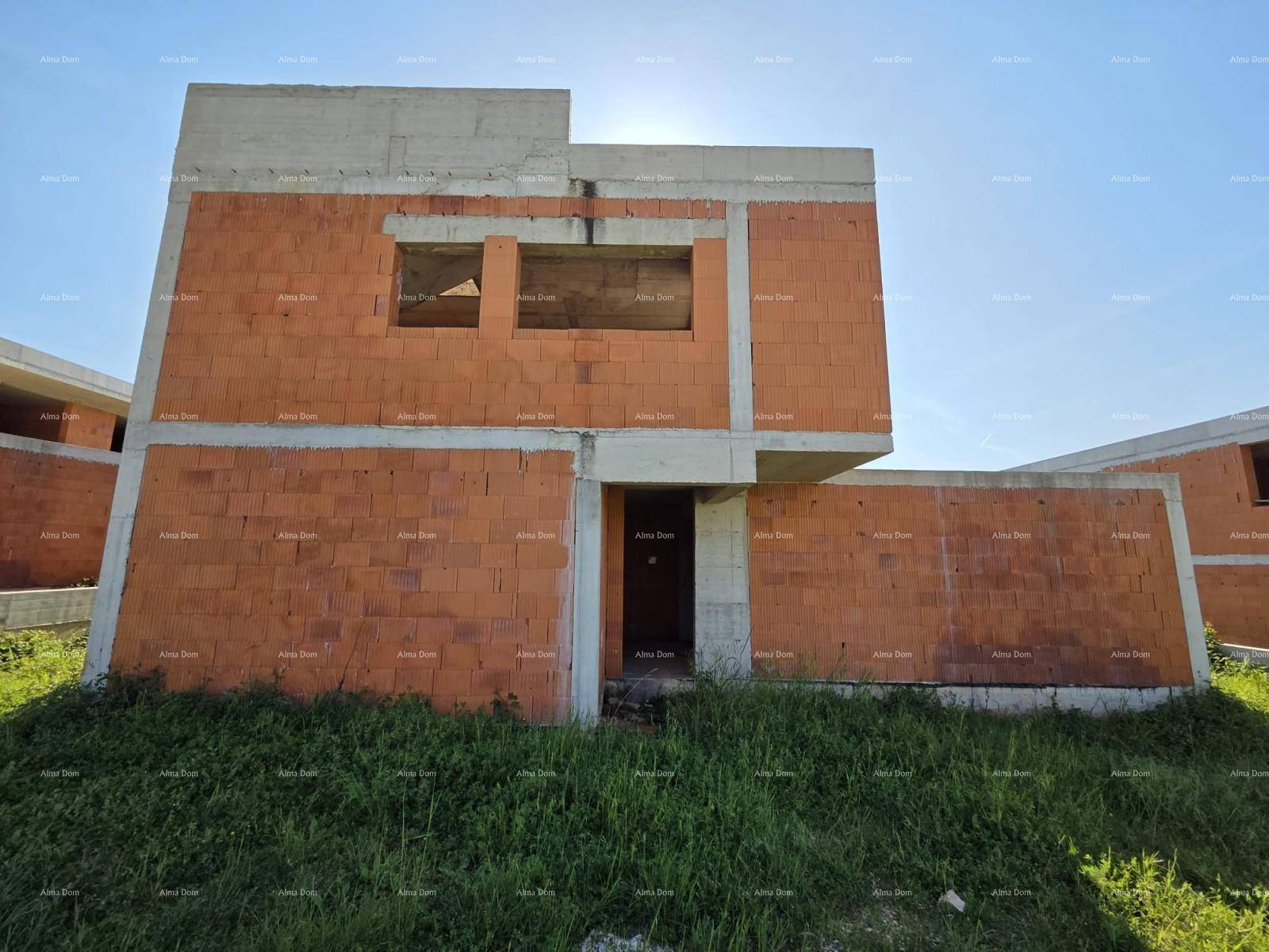 Nahaufnahme eines im Bau befindlichen Gebäudes mit unverputzten Ziegelwänden und sichtbaren Betonstrukturen.