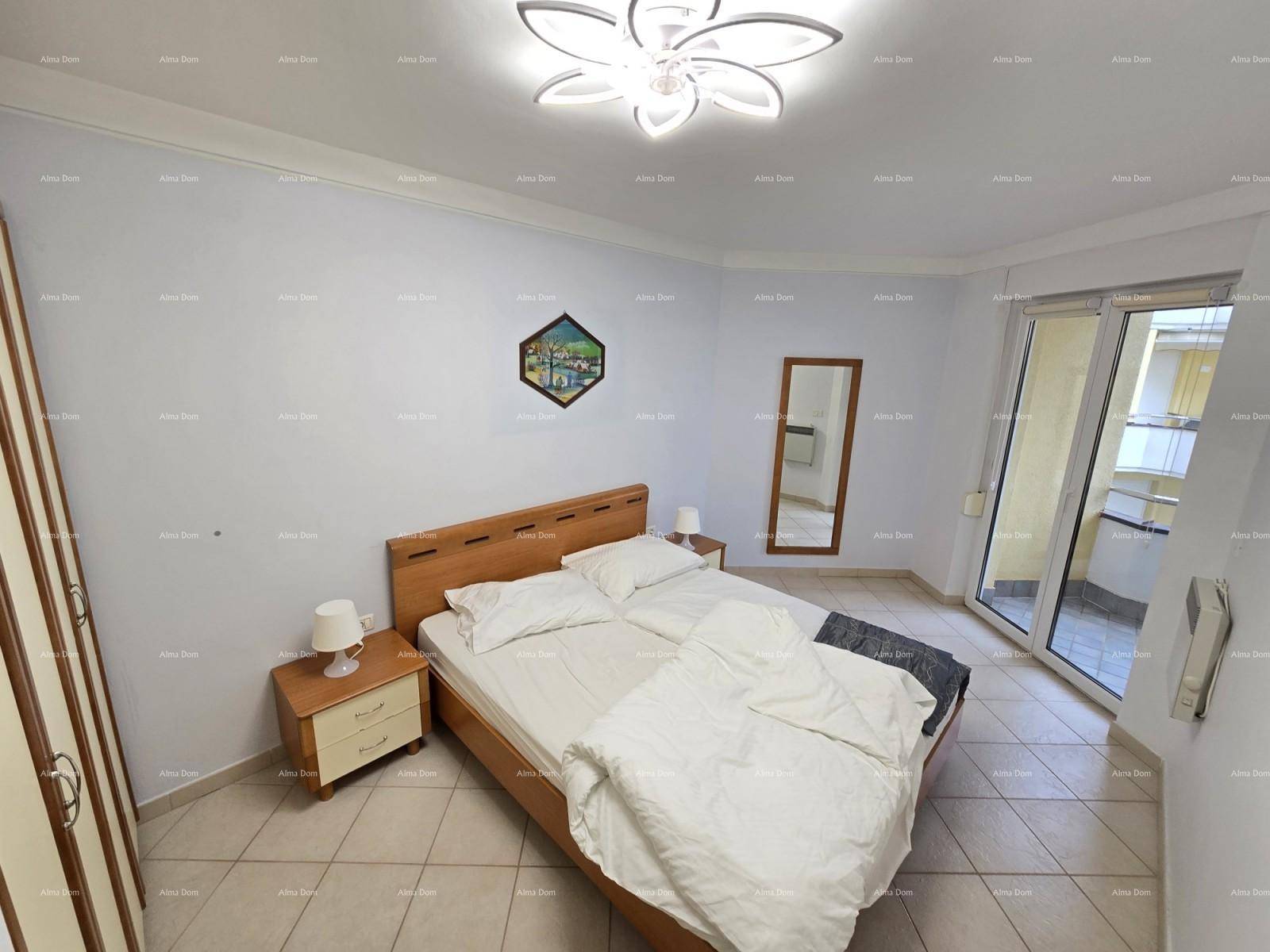 Schlafzimmer mit Doppelbett, Nachttischen und direktem Zugang zu einem sonnigen Balkon.