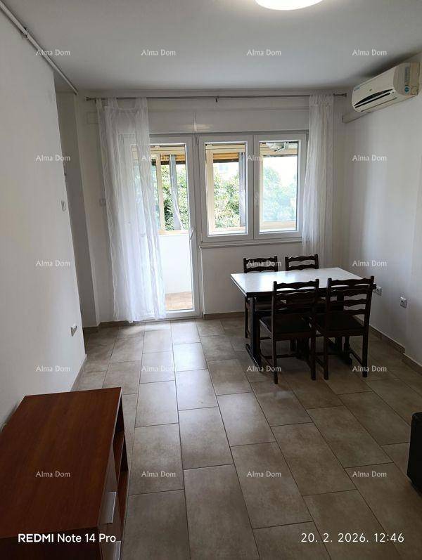 Heller Wohn- und Essbereich mit Esstisch, Fliesenboden und Zugang zu einem Balkon.