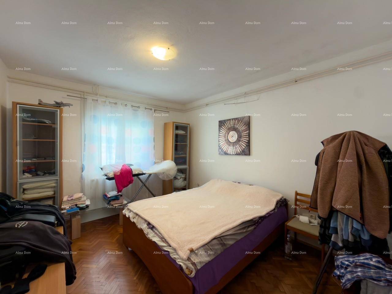 Schlafzimmer mit Doppelbett, Kleiderschränken und Fenster.