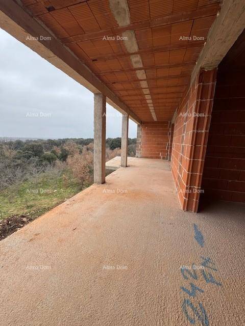 Langer, unfertiger Balkon mit Blick auf die grüne Umgebung und weitere Gebäude im Rohbau.