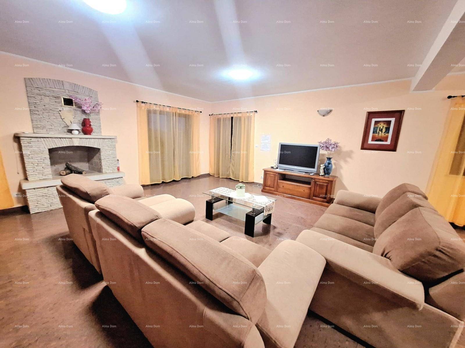 Geräumiges Wohnzimmer mit Kamin, beigen Sofas und Fenstern für natürliches Licht.