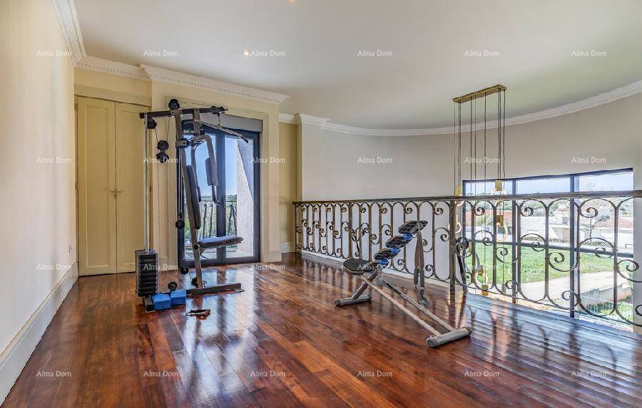Fitnessbereich auf der Galerie mit Trainingsgeräten und Blick ins Grüne.