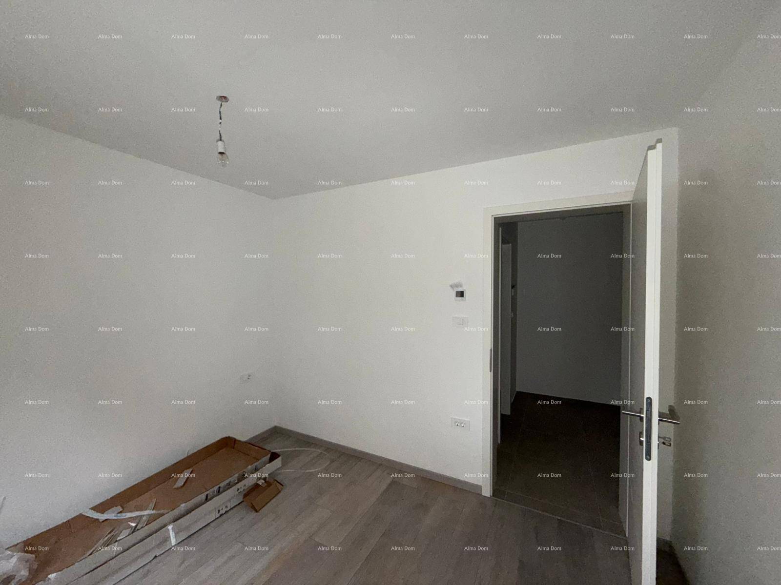 Helles, leeres Schlafzimmer mit Holzboden und weiß gestrichenen Wänden.