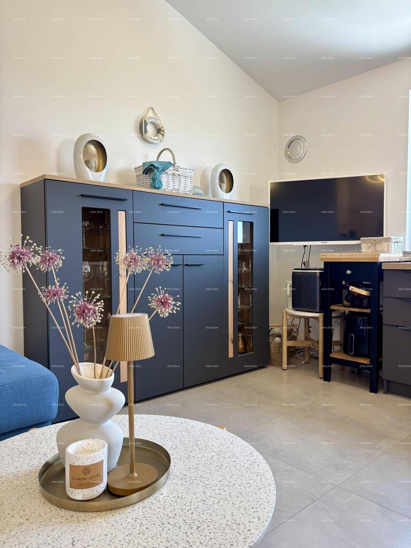 Detailansicht des Wohnbereichs mit modernem Sideboard, Couchtisch und Dekoration.