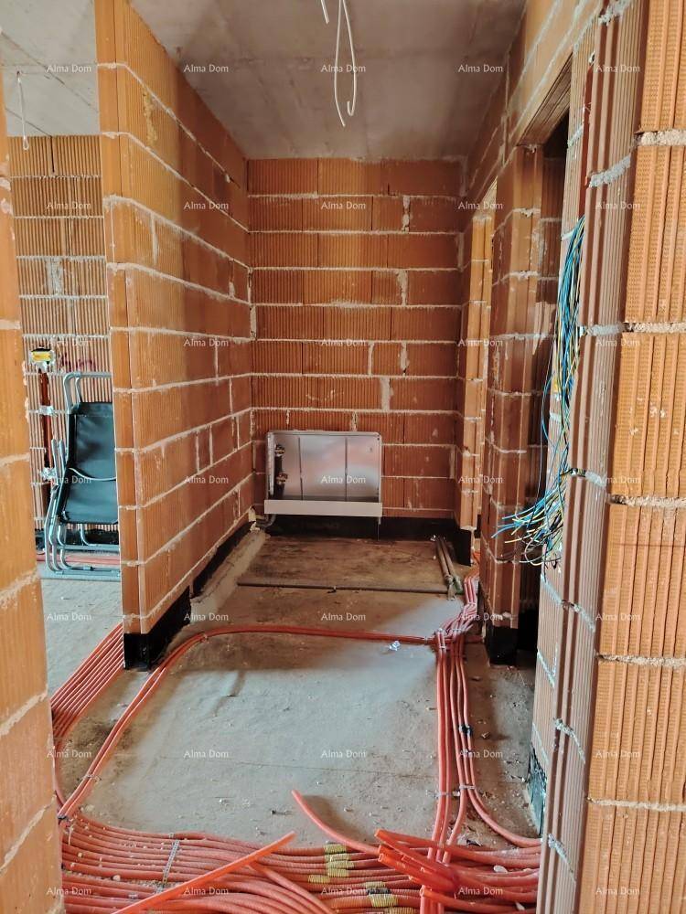 Badezimmer im Rohbau mit Ziegelwänden, Betonboden und Vorinstallation für ein wandhängendes WC.