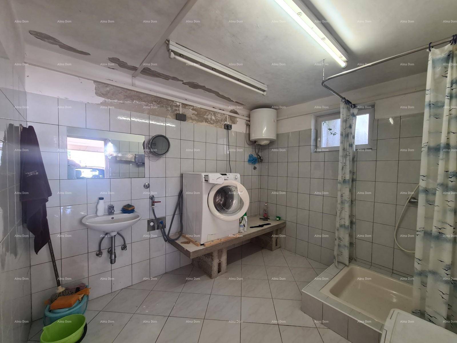 Waschküche im Untergeschoss mit Waschmaschine, Dusche und Waschbecken.