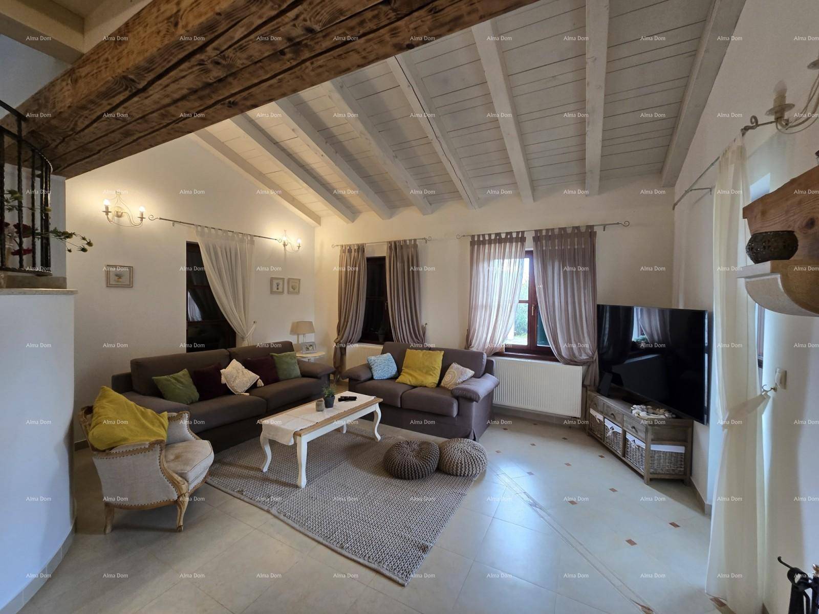 Geräumiges Wohnzimmer mit hohen Decken, sichtbaren Holzbalken und großen Fenstern für viel Licht.