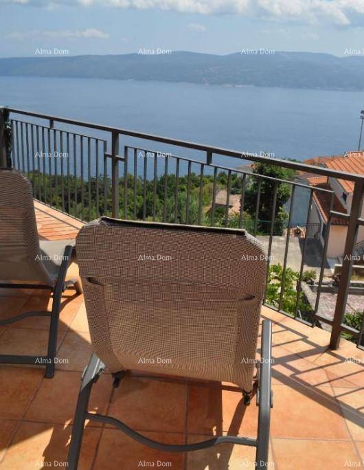 Entspannungsbereich auf dem Balkon mit Sonnenliege und weitem Blick auf das Meer.