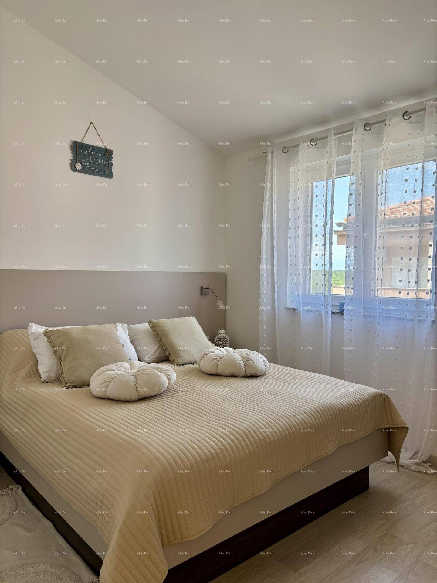 Helles Schlafzimmer mit Doppelbett, Fenster und Vorhängen.