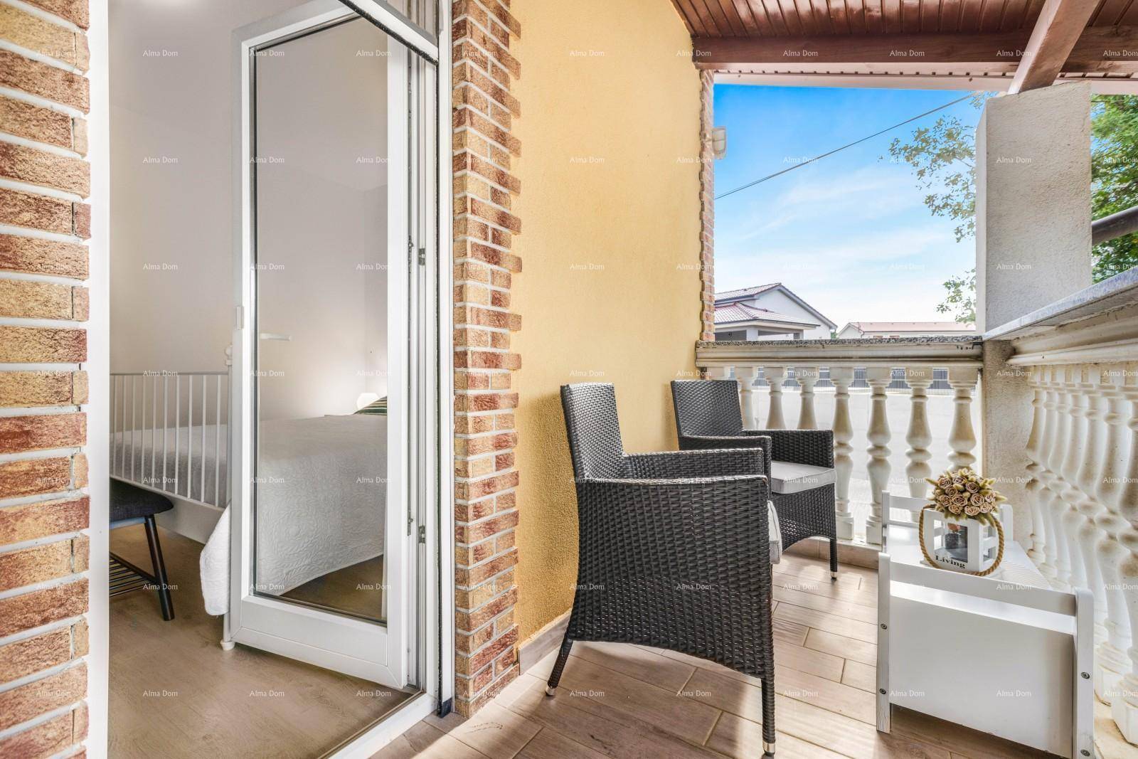 Gemütlicher Balkon mit Sitzgelegenheiten und Blick auf die Umgebung unter blauem Himmel.