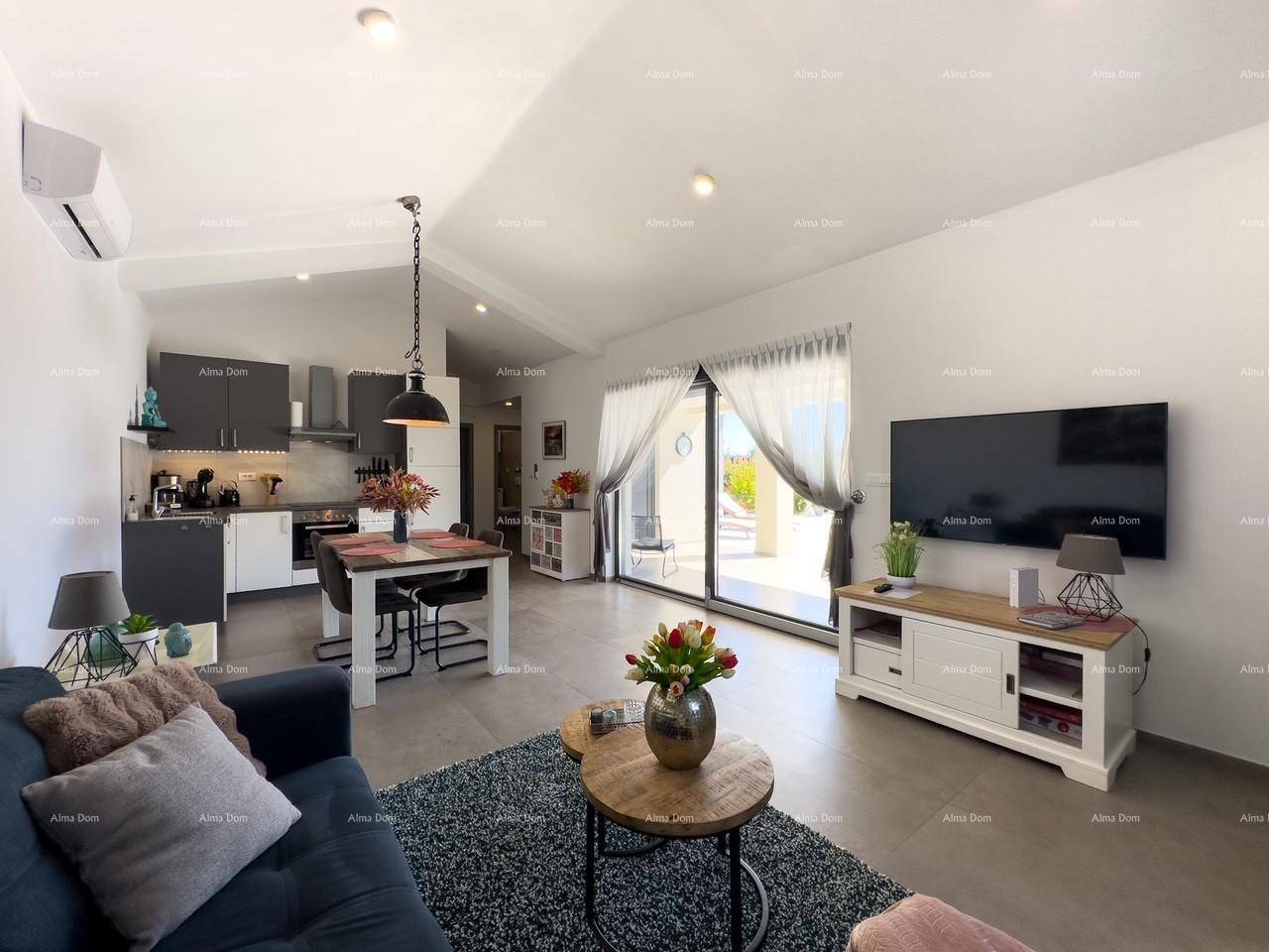 Heller Wohn-Essbereich mit offener Küche, Sofa und Zugang zur Terrasse.