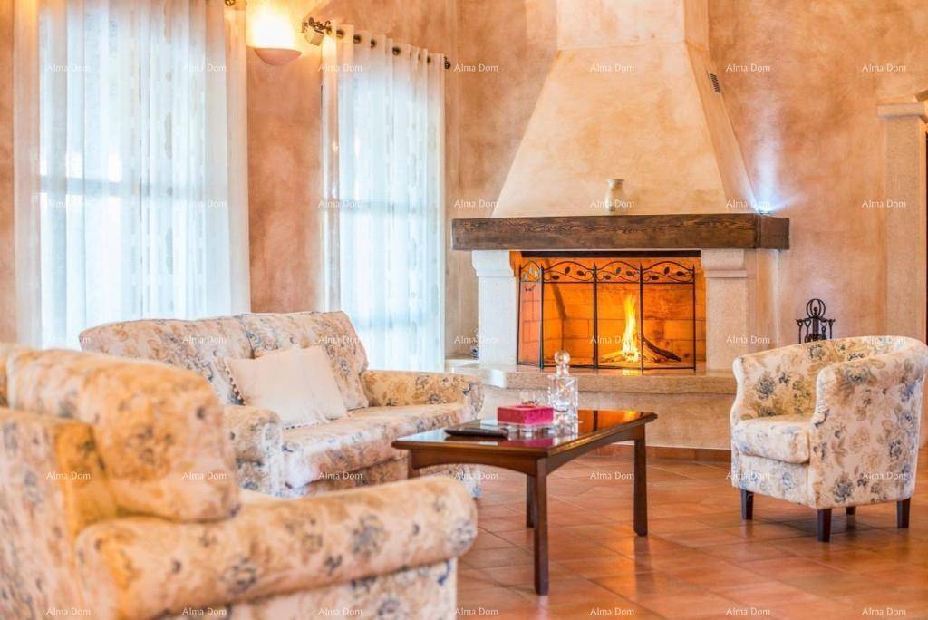 Einladendes Wohnzimmer mit brennendem Kamin, floral gemusterten Sofas und warmen Farben.