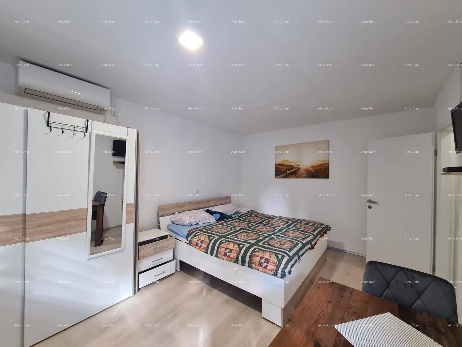 Schlafzimmer mit Doppelbett, großem Kleiderschrank und Fernseher an der Wand.