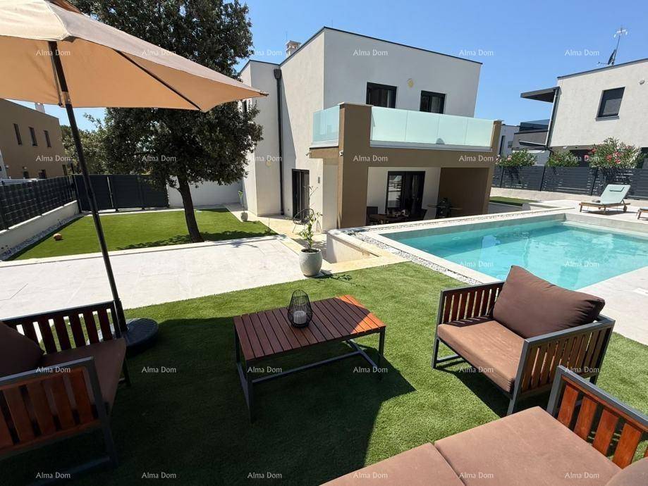 Gepflegter Gartenbereich mit Pool, bequemen Outdoor-Möbeln und Sonnenschirm für entspannte Stunden.