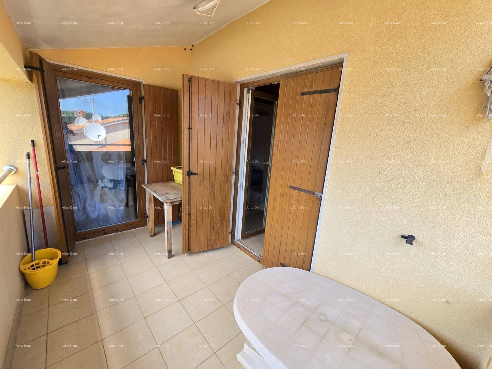 Überdachter Balkon mit Fliesenboden und Blick auf die Umgebung.