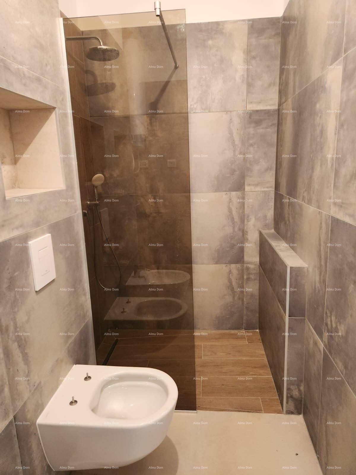 Modernes Badezimmer mit begehbarer Dusche, Wand-WC und großformatigen Fliesen.