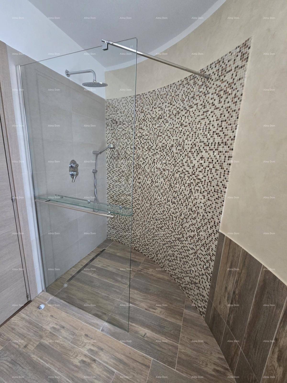 Moderne Duschkabine mit Glasabtrennung, Regendusche und dekorativen Mosaikfliesen.