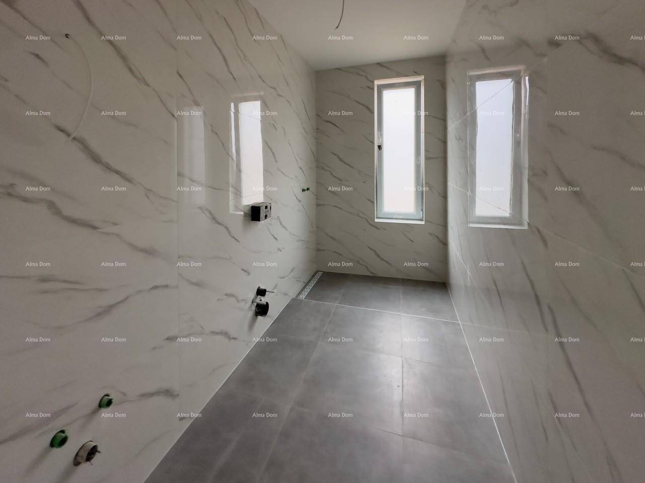Badezimmer im Rohbau mit modernen Marmorfliesen und schmalen Fenstern, bereit für Installationen.