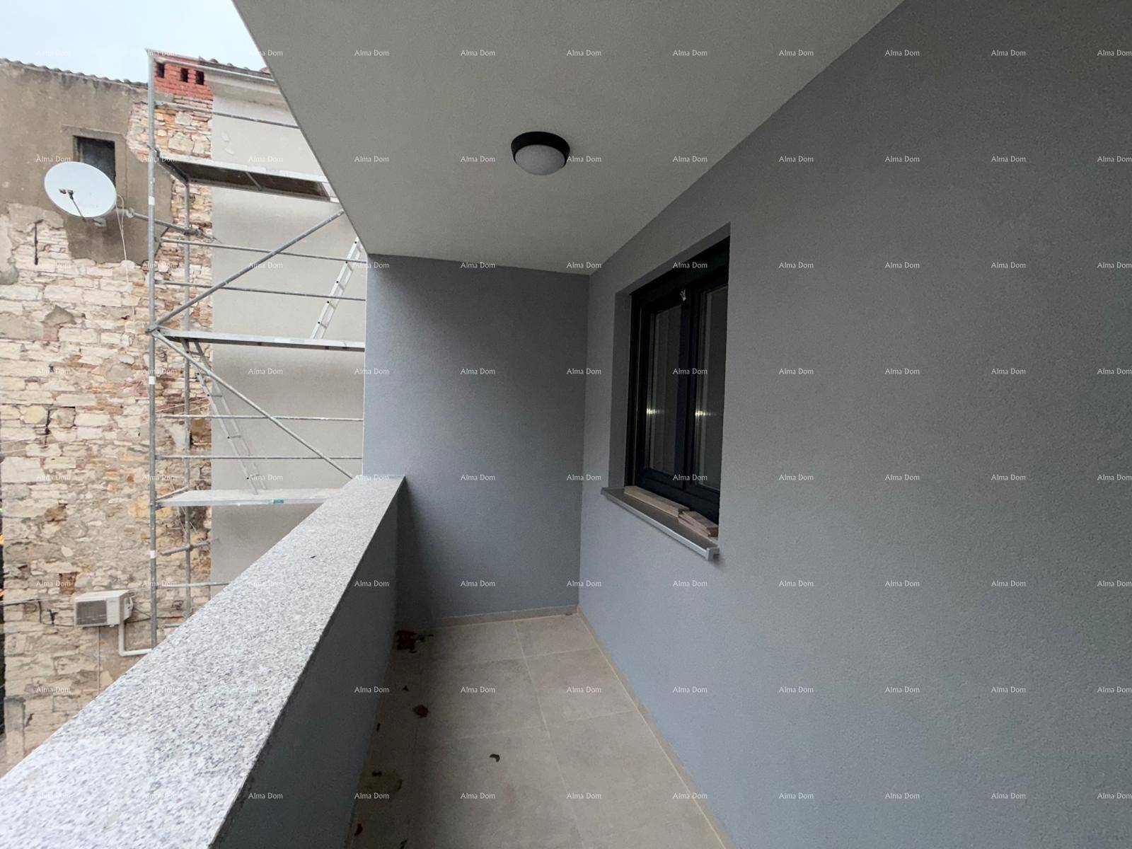 Heller Balkon mit grauen Wänden und Fliesenboden, bietet einen Blick auf die Nachbarschaft.