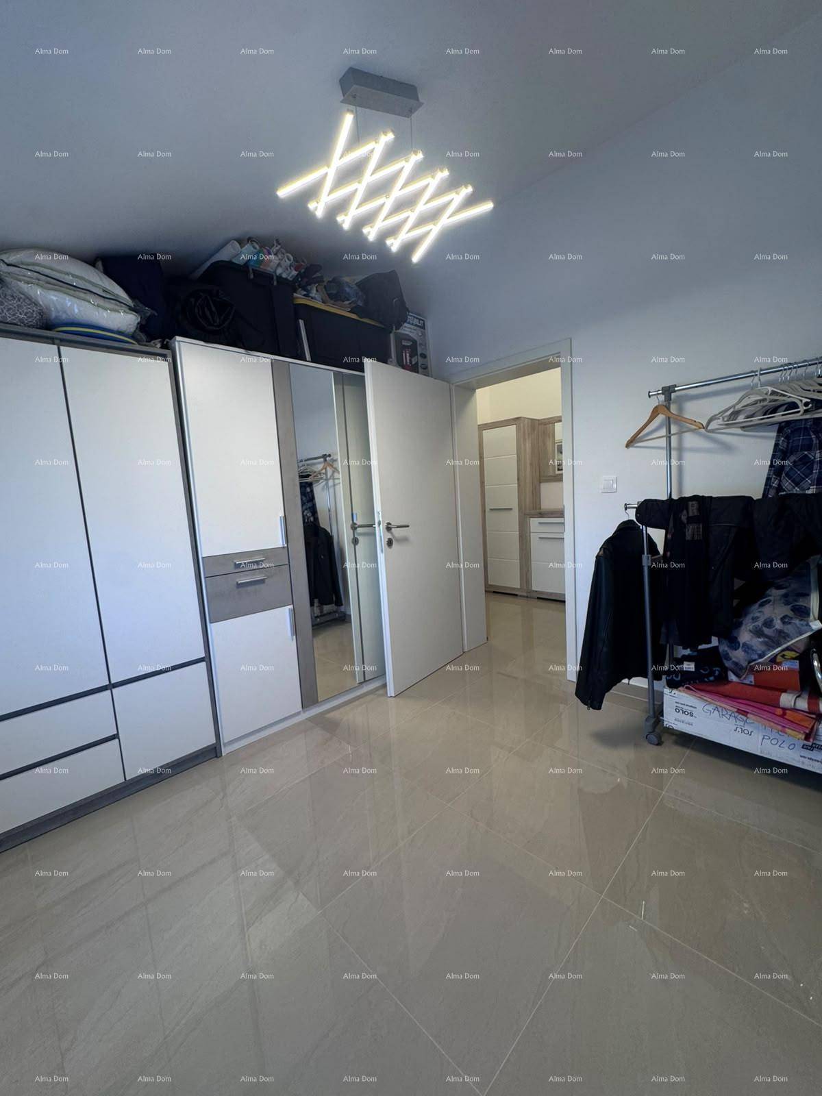 Schlafzimmer mit Kleiderschrank und Kleiderstange, bietet Stauraum und Helligkeit.
