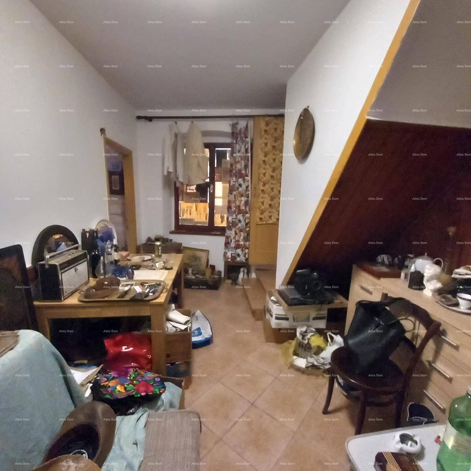 Wohnbereich mit Dachschräge, Fenster und vielen persönlichen Gegenständen.