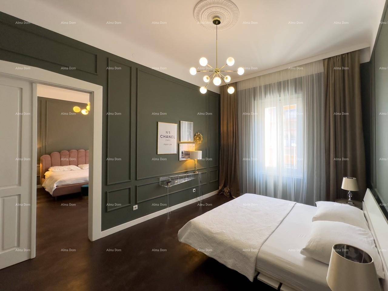 Helles Schlafzimmer mit dunklem Parkettboden, grünen Wandpaneelen und einem modernen Doppelbett.