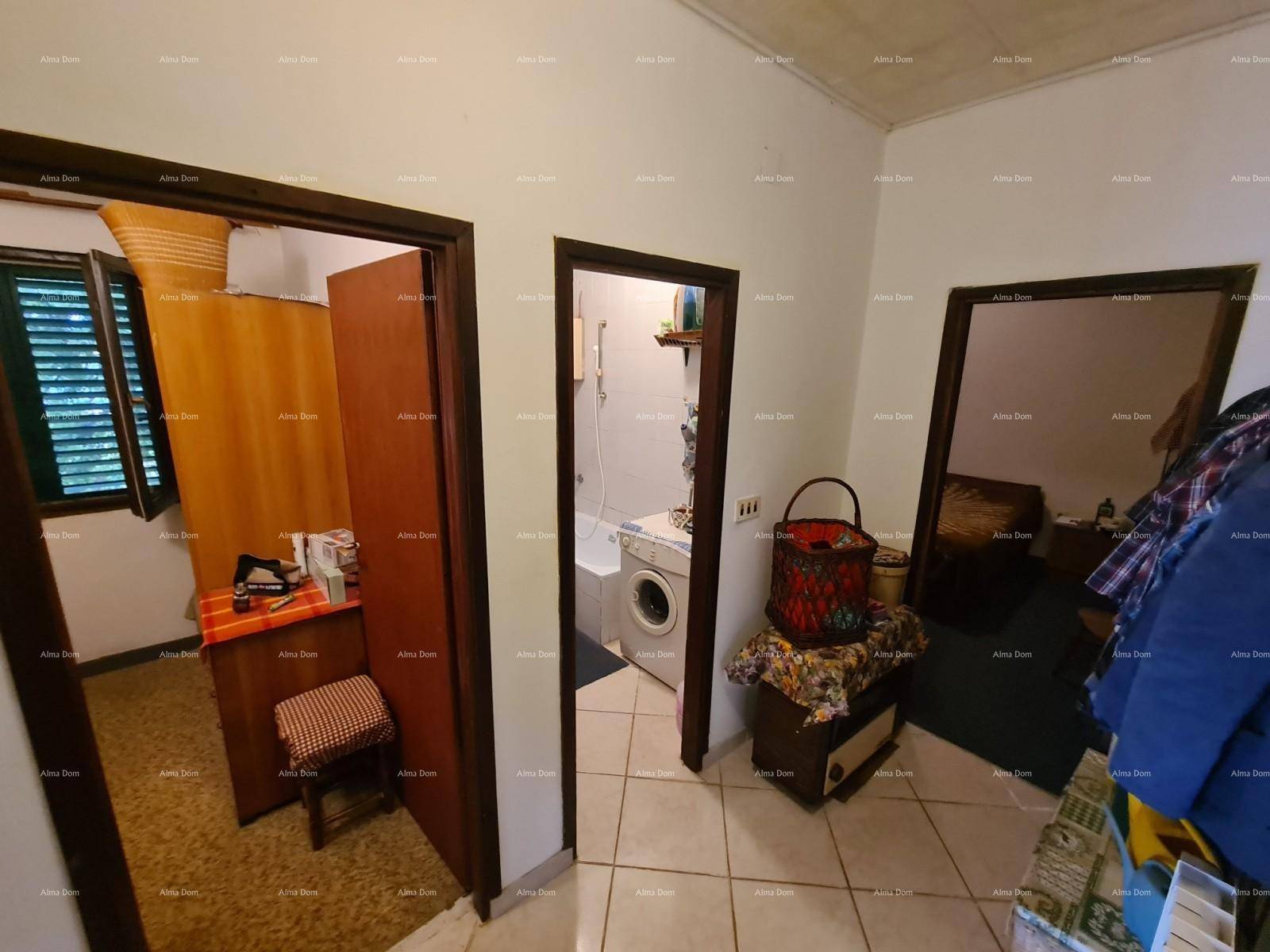 Flur mit Fliesenboden und offenen Türen, die zu einem Schlafzimmer und einem Badezimmer führen.