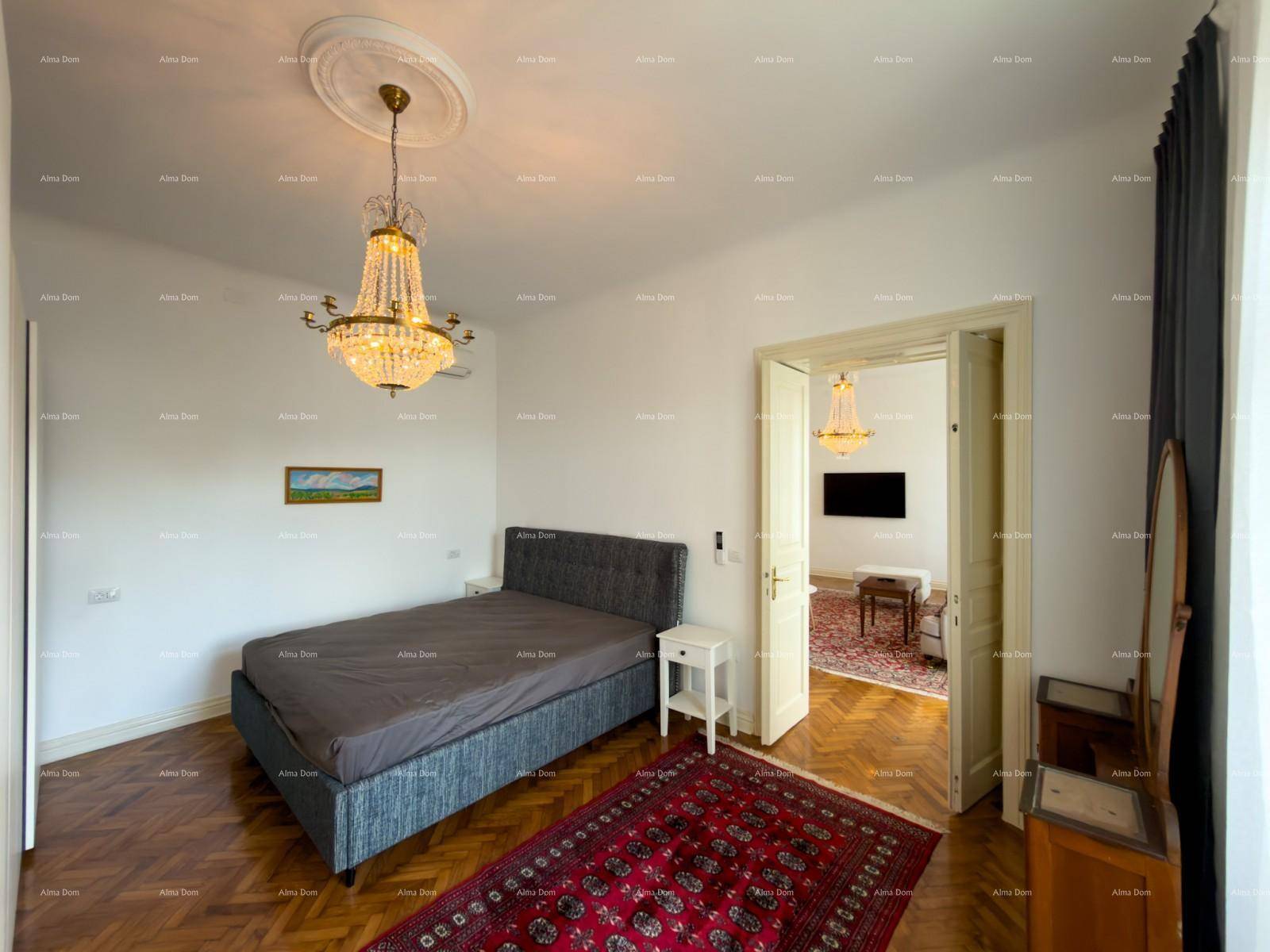 Schlafzimmer mit Doppelbett, Nachttisch und Blick durch die offene Tür ins angrenzende Wohnzimmer.
