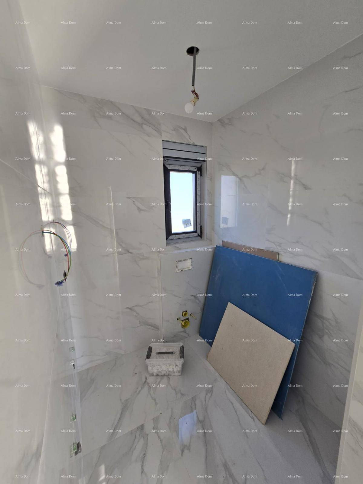 Modernes Badezimmer im Rohbau mit großformatigen Marmorfliesen und Fenster für Tageslicht.