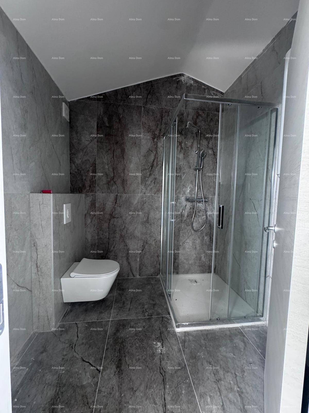 Modernes Badezimmer mit dunklen Marmorfliesen, wandhängendem WC und Glasduschkabine unter schräger Decke.