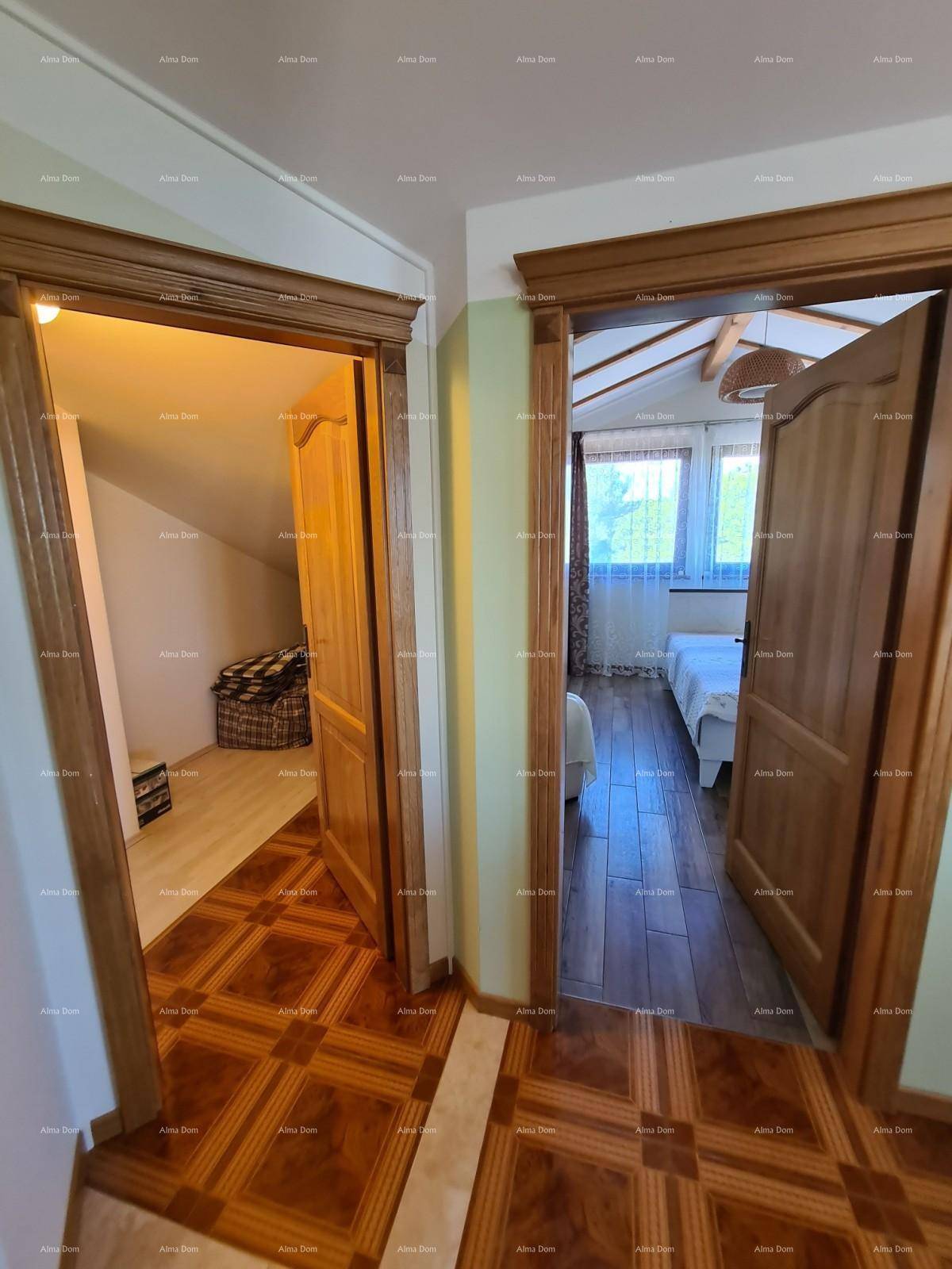 Flur mit Holztüren, der den Zugang zu zwei hellen Schlafzimmern im Dachgeschoss ermöglicht.