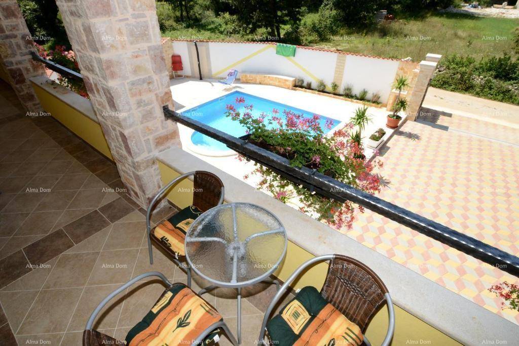 Gemütlicher Balkon mit Sitzgelegenheiten und Blick auf den Poolbereich.