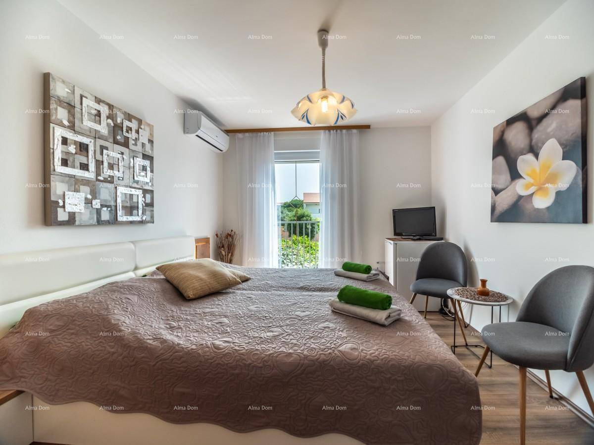 Helles Schlafzimmer mit Doppelbett, Klimaanlage und direktem Zugang zu einem Außenbereich.