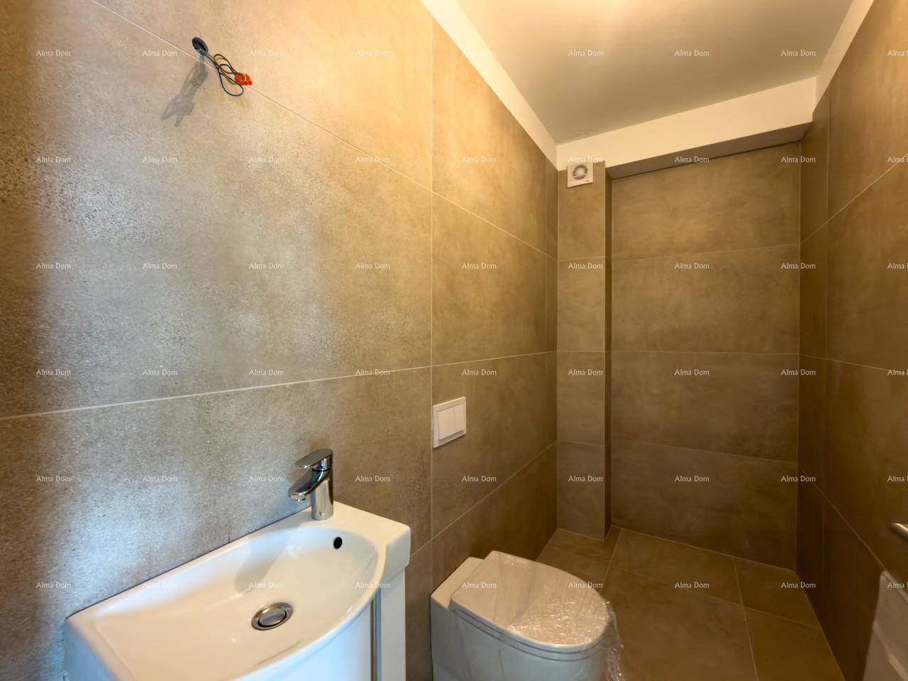 Modernes Gäste-WC mit beigefarbenen Fliesen, wandhängendem Waschtisch und WC.