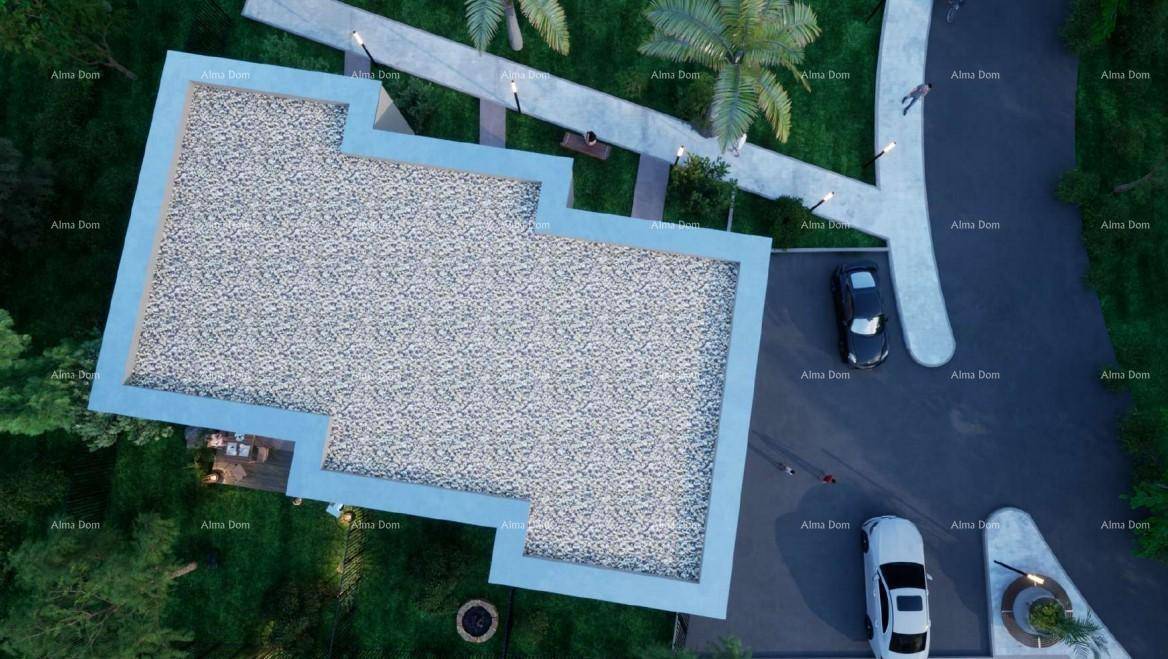 Luftaufnahme des modernen Gebäudekomplexes mit Flachdach, Grünflächen und Parkplätzen.