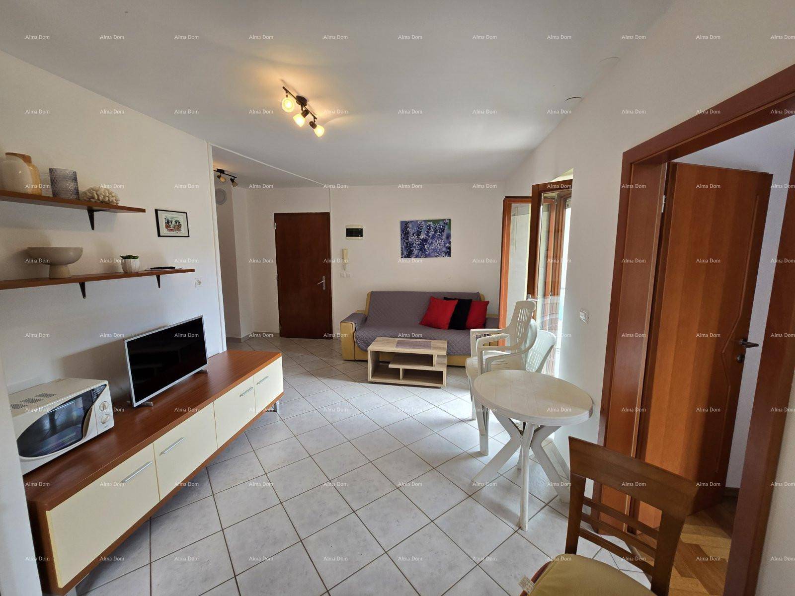 Heller Wohnbereich mit Sofa, TV-Möbeln und Essbereich, der zum Balkon führt.