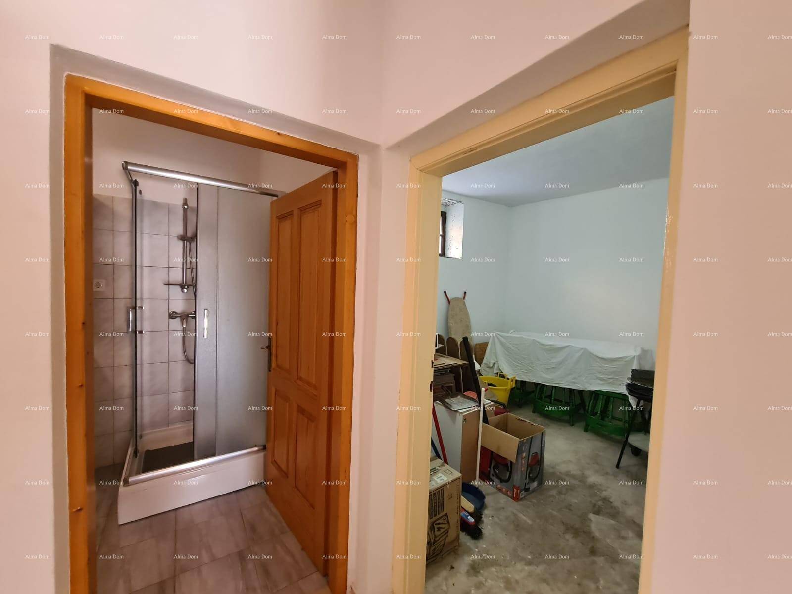 Zwei offene Türen führen zu einem Badezimmer mit Dusche und einem praktischen Abstellraum.