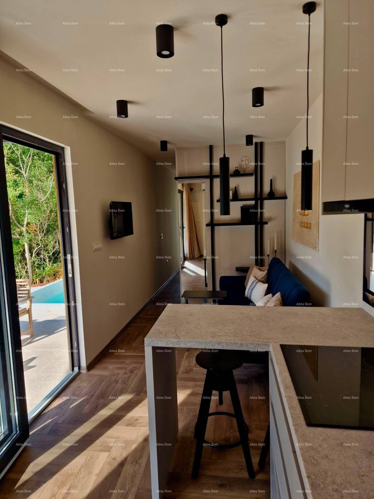 Offener Wohnbereich mit moderner Küchenzeile, Holzboden und Zugang zur Terrasse mit Pool.