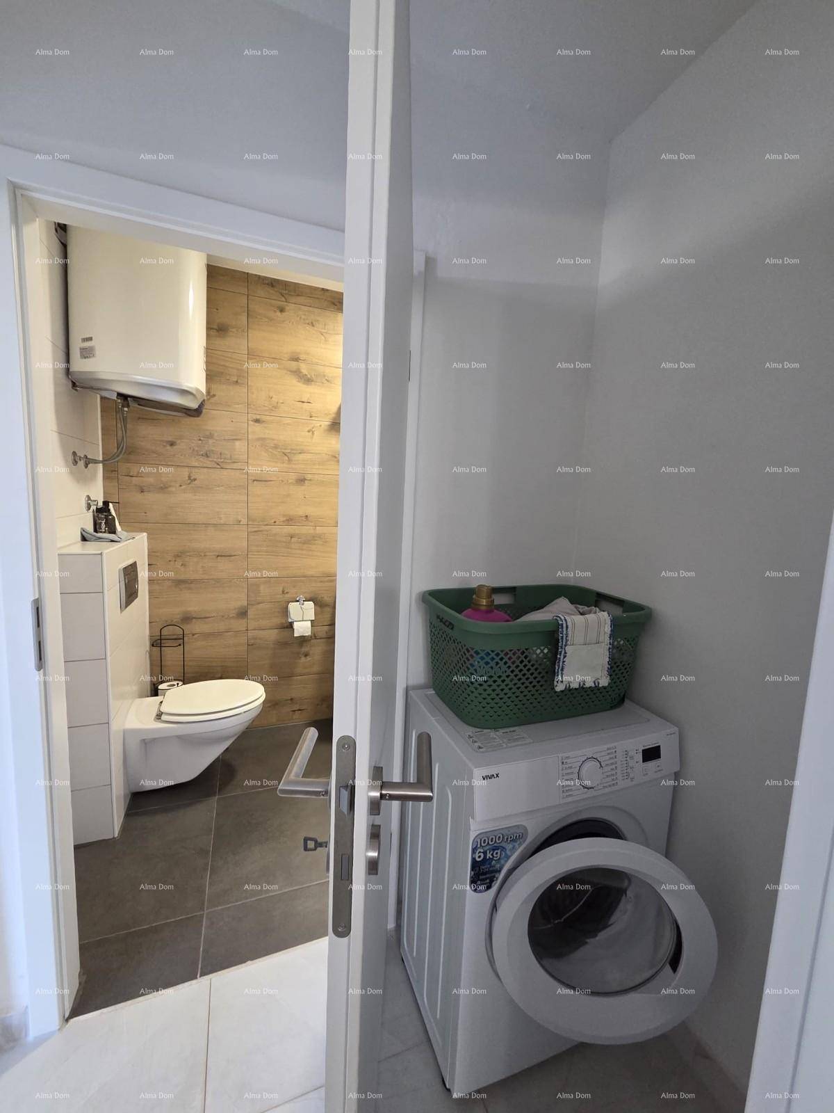 Praktischer Hauswirtschaftsraum mit Waschmaschine und Zugang zum modernen Badezimmer.