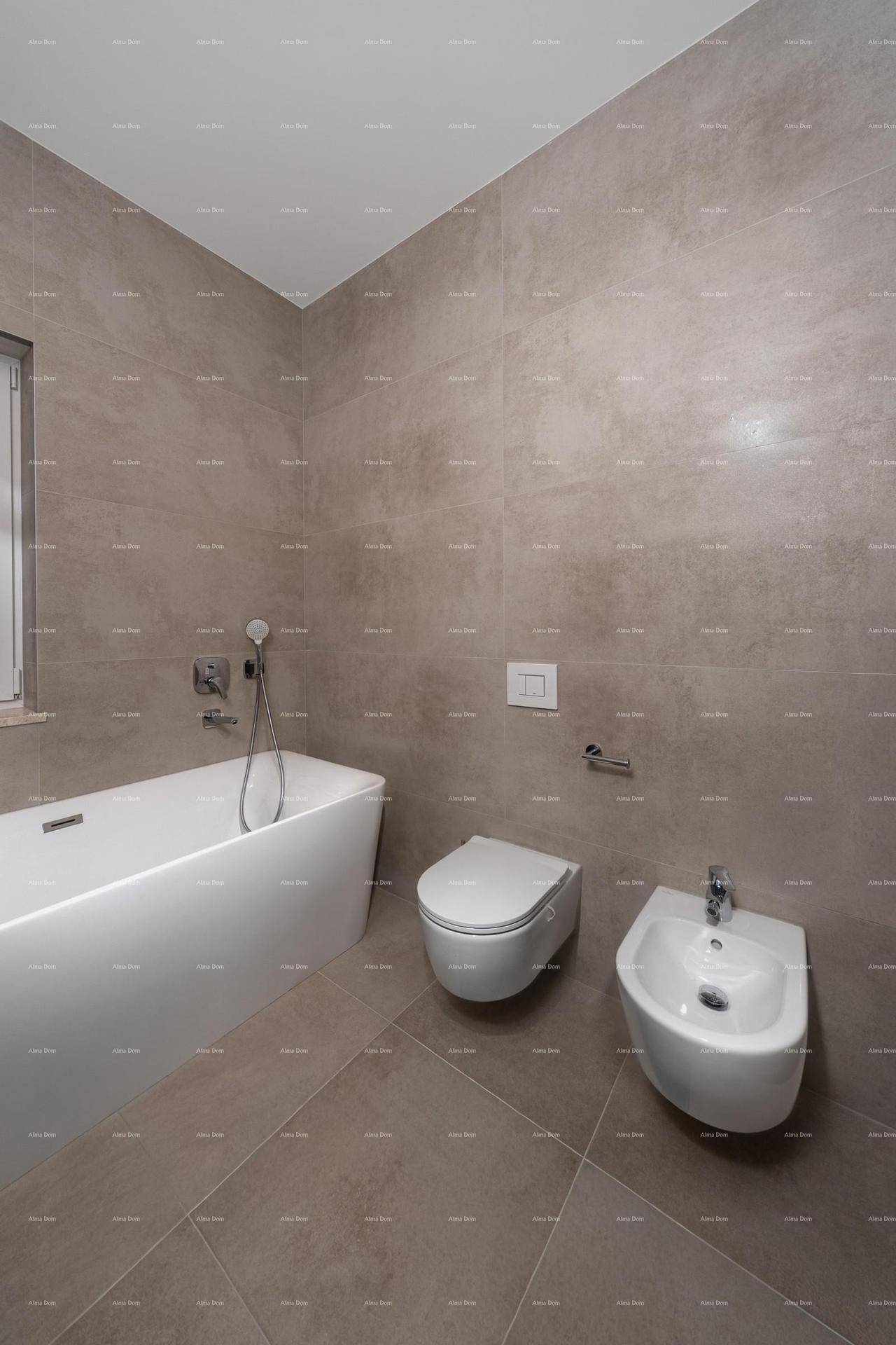 Modernes Badezimmer mit Badewanne, wandhängender Toilette und Bidet, gefliest in Grautönen.