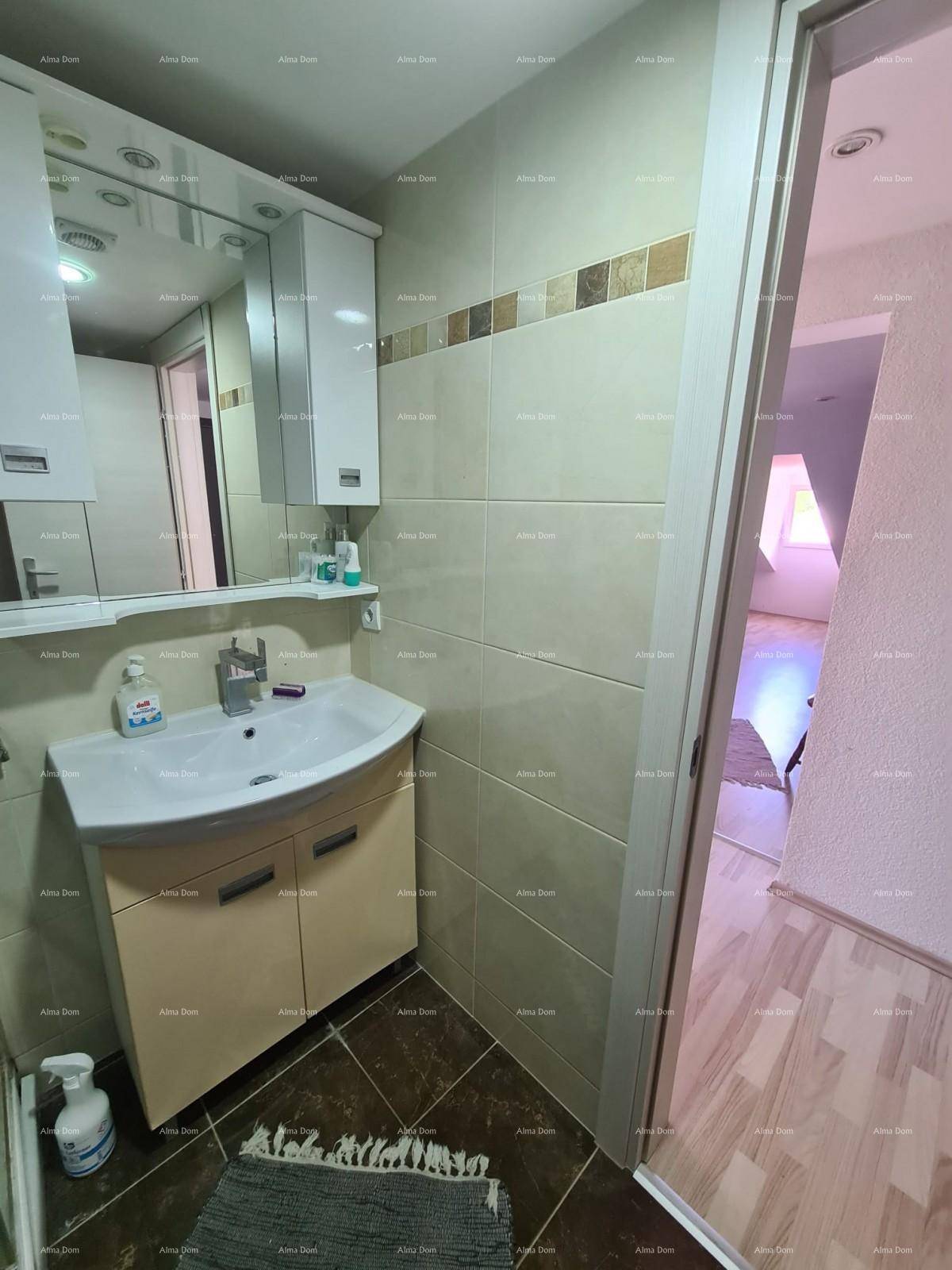 Modernes Badezimmer mit Waschtisch, Spiegelschrank und hellen Fliesen an den Wänden.