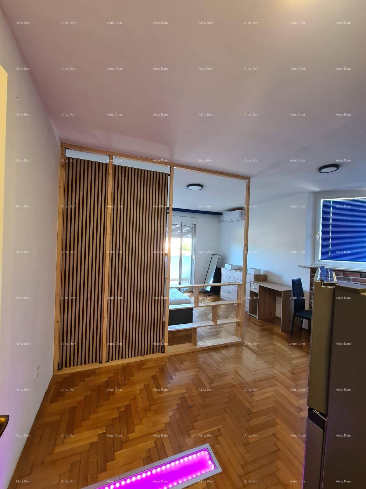 Offener Wohnbereich mit Holzboden und dekorativer Holzlamellenwand.