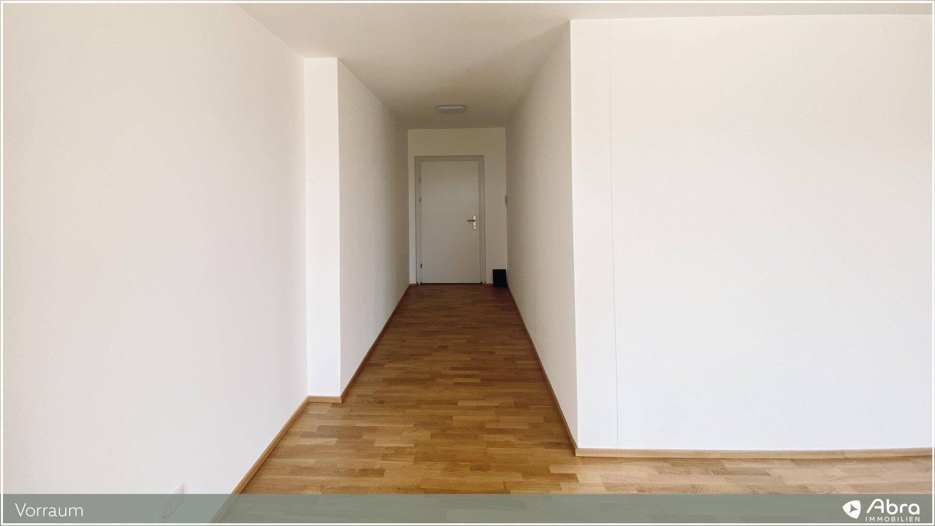 Heller Flur mit Parkettboden und Zugang zu weiteren Räumen, einladend und funktional.