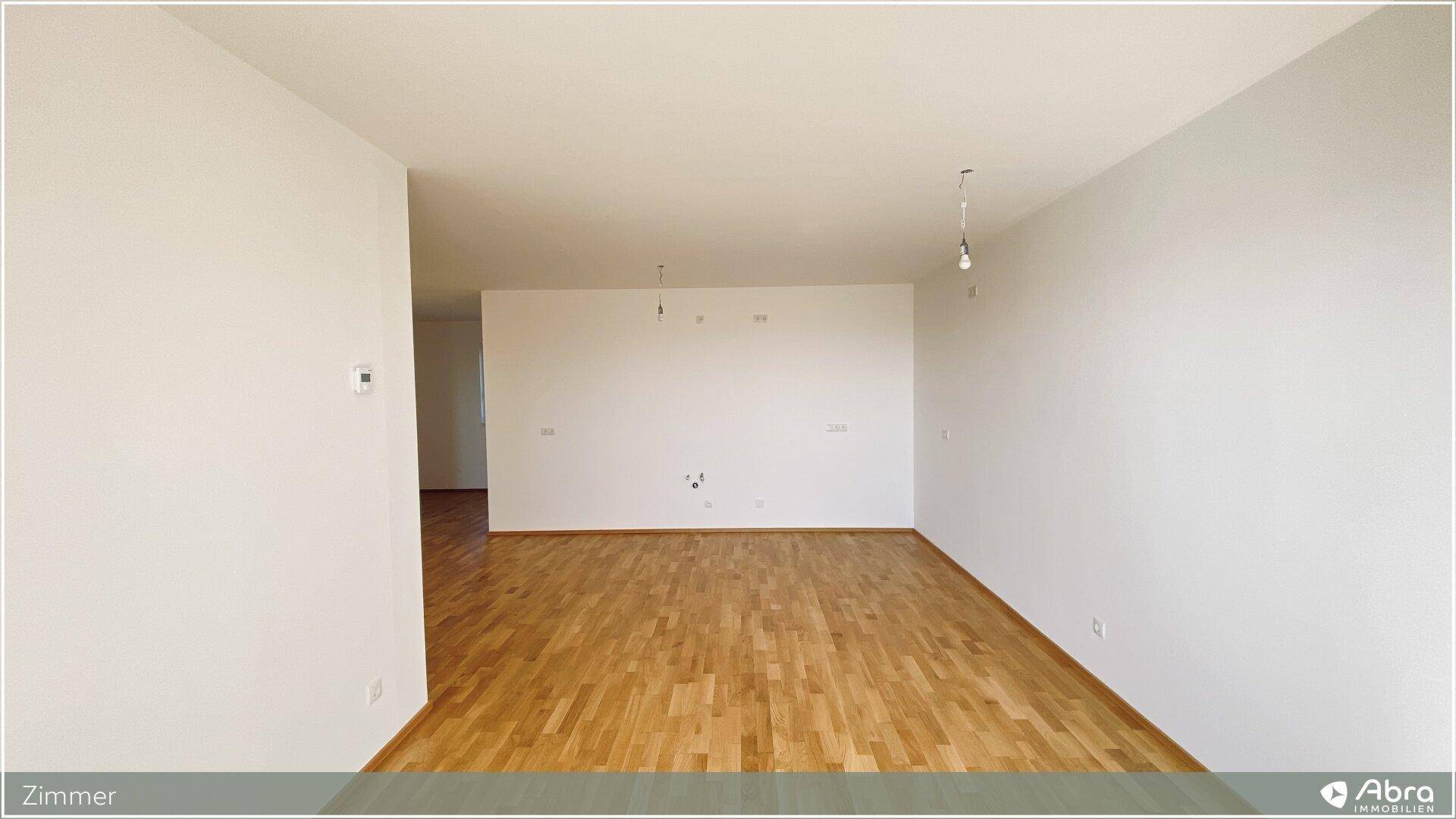 Helles, unmöbliertes Zimmer mit Parkettboden, ideal als Schlaf- oder Kinderzimmer.