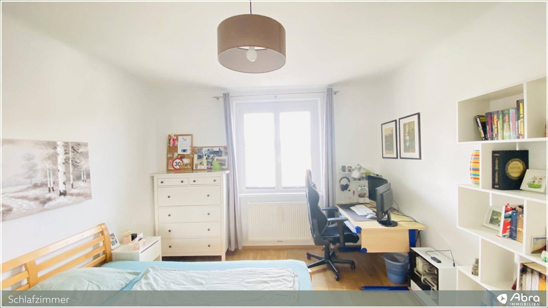 Helles Schlafzimmer mit Einzelbett, Schreibtisch und Bücherregal, ideal für Kinder oder Gäste.