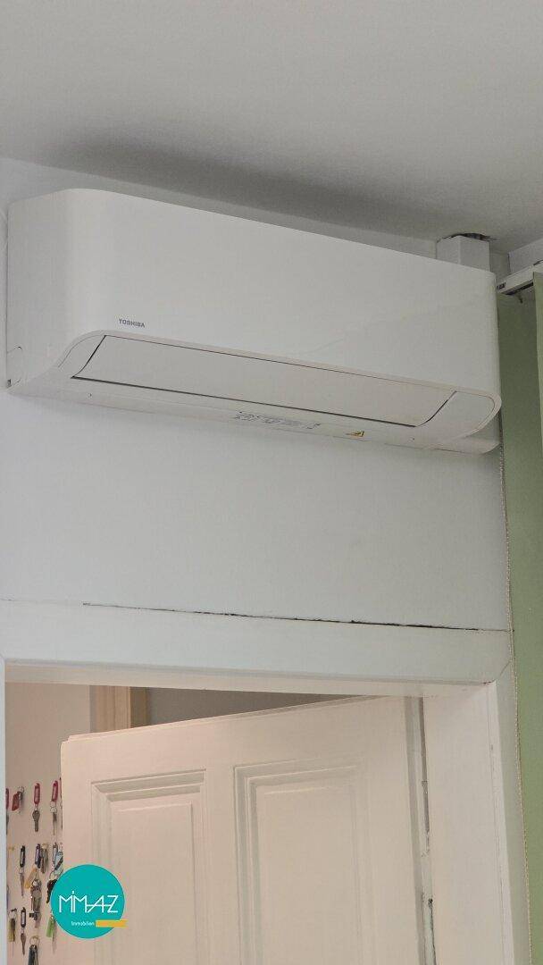 Klimaanlage über einer Tür, die für Kühlung oder Heizung in diesem Bereich sorgt.