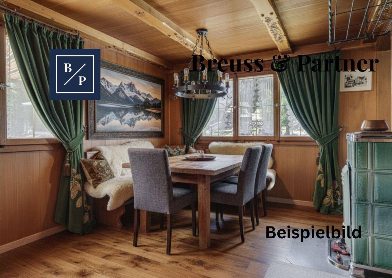 Gemütlicher Essbereich mit Holzwänden, Holzbalkendecke und traditionellem Kachelofen.